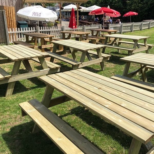 8 seater timber pub style picnic benches in a pub garden