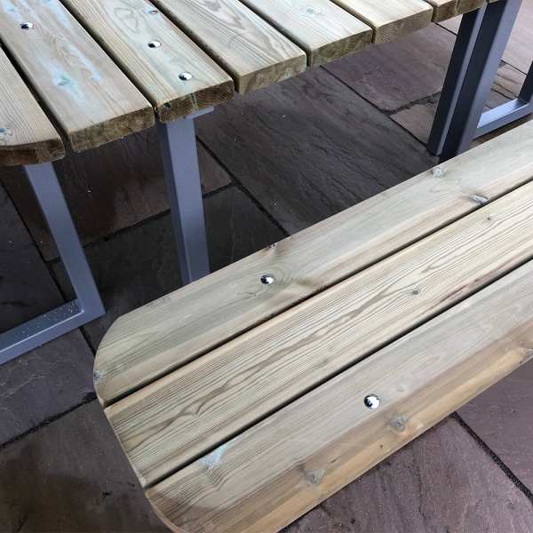 Picnic bench seat and table top made from smooth rounded timber and a galvanised steel frame