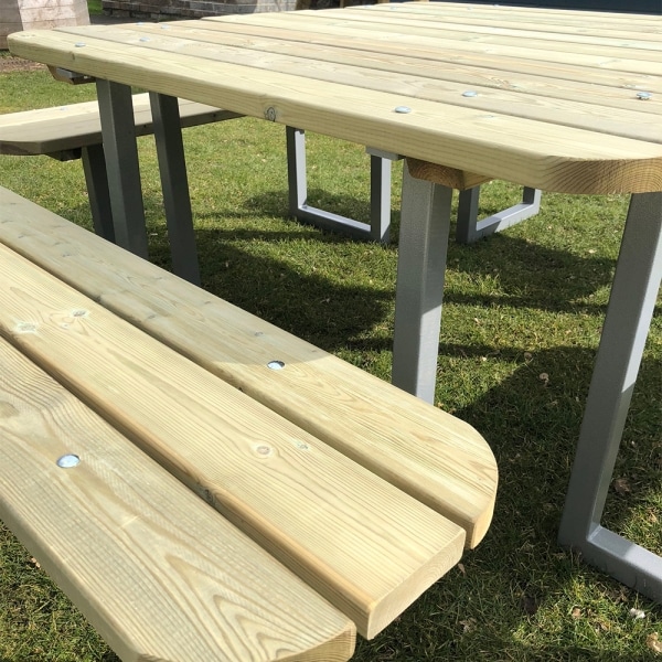 Modern timber picnic table with steel frame and rounded edge sto seat 12 people