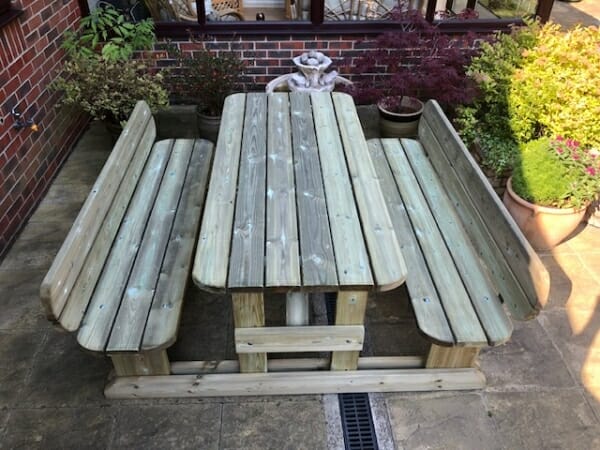 Timber H-frame picnic bench with rounded corners and seat backs