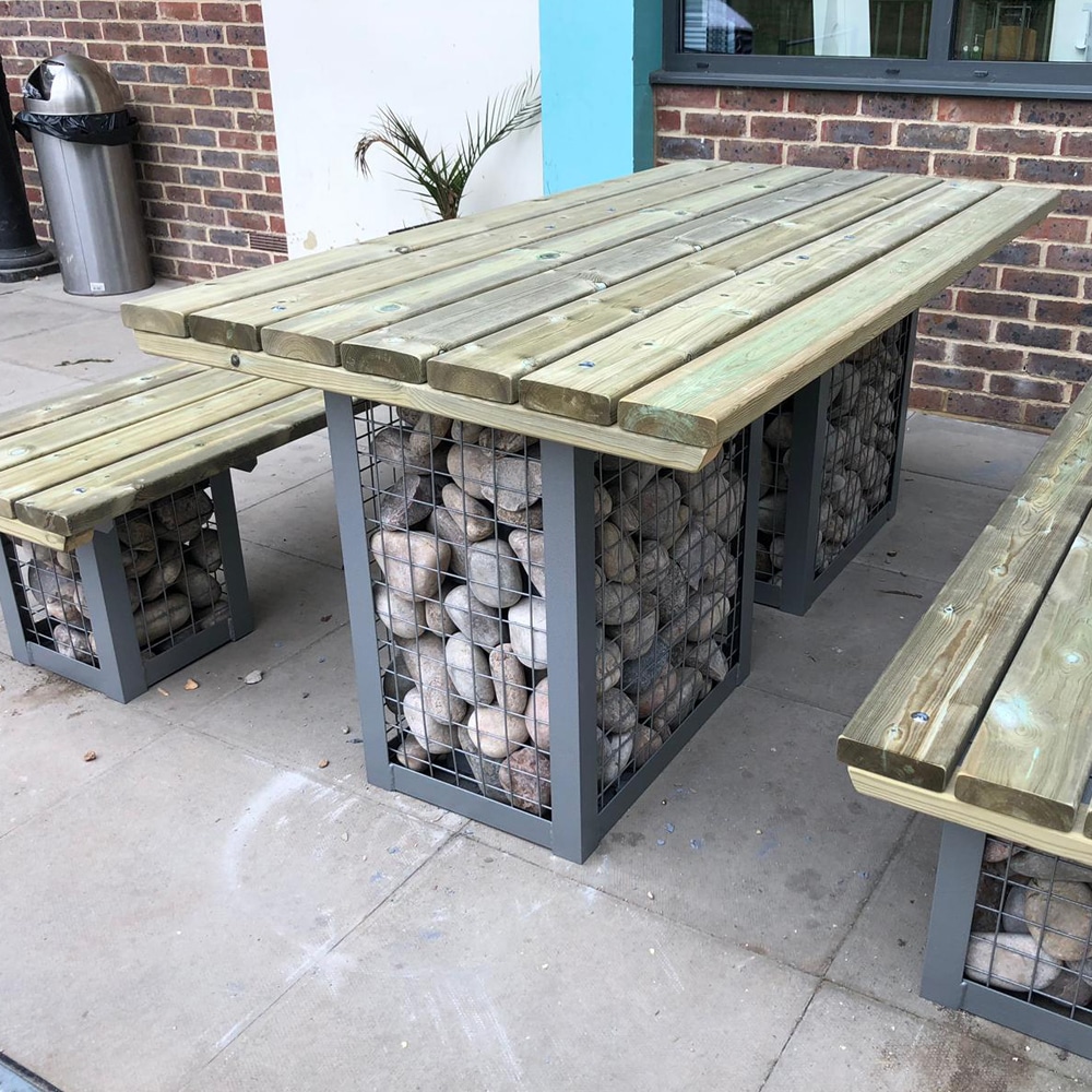 Modern timber picnic table with stone filled steel gabions and matching benches